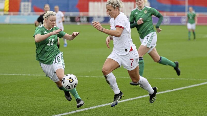 Rachel Daly of England runs with the ball under pressure from Nadene Caldwell of Northern Ireland at St George&#39;s Park. 