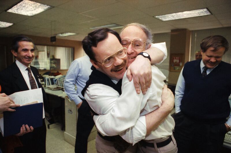 Terry Anderson hugs colleague Jim Abrams during a visit to the Washington bureaus of The Associated Press in Washington in December 1991 (AP)