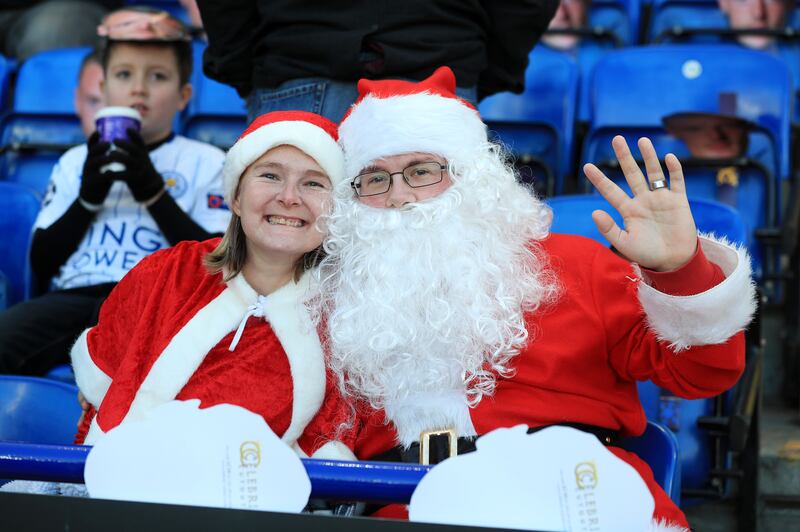 Fans in Santa Claus fancy dress in the stands before the Premier League match at the King Power Stadium, Leicester