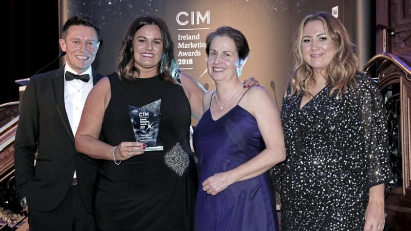 Niamh Taylor, managing director of Digital 24, receives the Chair&#39;s Award for Best Campaign at the recent CIM Ireland Marketing Awards from chair Eileen Curry. Included are event hosts Stephen Clements and Cate Conway from Q Radio 