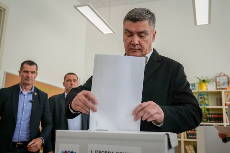 Croatian President Zoran Milanovic casts his vote at a polling station in Zagreb (Darko Bandic/AP)