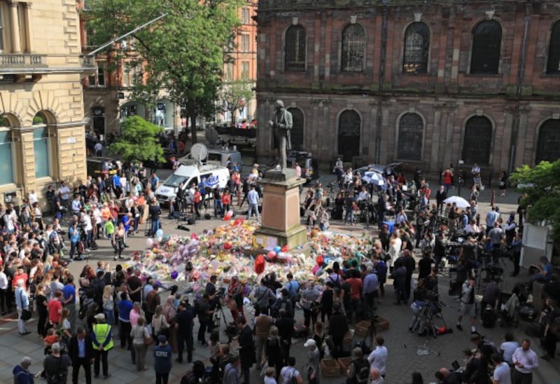 people look at flowers in St Ann's Square, Manchester