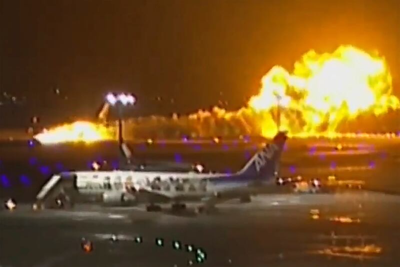 The Japan Airlines plane burst into flames on the runway of Haneda airport (NTV/AP)