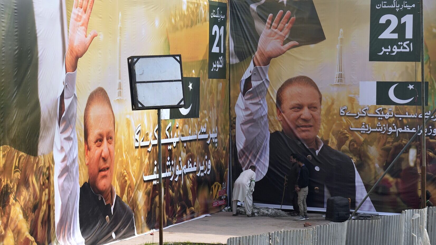 Huge portraits of Nawaz Sharif at the venue of his welcoming rally in Lahore (KM Chaudary/AP)