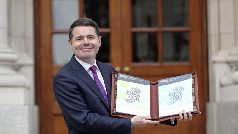               Finance Minister Paschal Donohoe holds his tax and expenditure reports outside Government buildings in Dublin before delivering his budget speech. PRESS ASSOCIATION Photo. Picture date: Tuesday October 10, 2017. See PA story IRISH Budget. Following last-minute talks with the king-makers on opposition benches, all eyes will be on modest cuts to income tax, initiatives to ease the country&#39;s unprecedented housing and homelessness crisis and modest welfare rises. Photo credit should read: Niall Carson/PA Wire             
