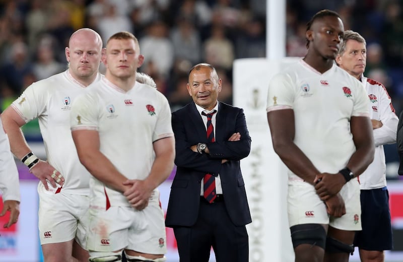 Eddie Jones, centre, stands with his players after the 2019 Rugby World Cup final 