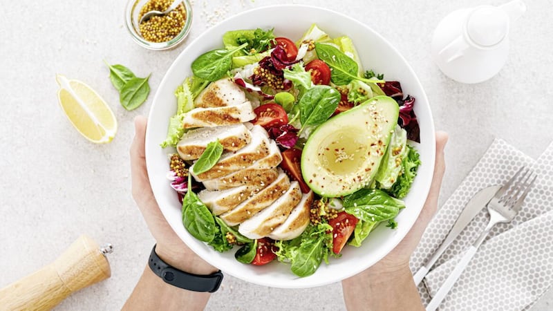 Grilled chicken meat and fresh vegetable salad of tomato, avocado, lettuce and spinach is a nutritious and healthy meal 