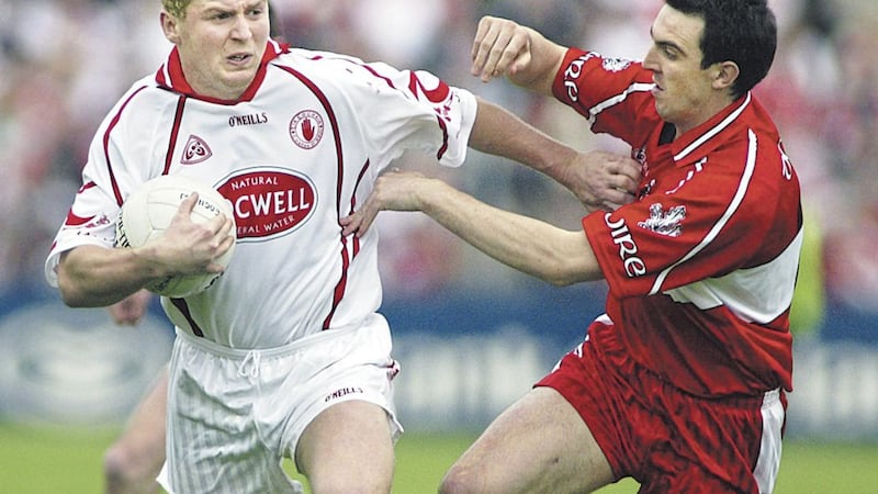 Tyrone&#39;s Owen Mulligan fends off Derry&#39;s Kevin McGuckin an Ulster Championship match in Healy Park, Omagh on May 28 2006. Picture by Ann McManus. 