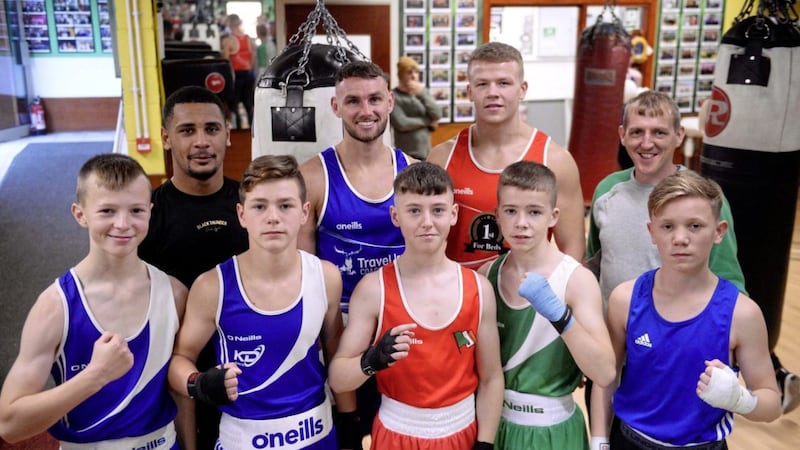 Michael Marlow, Caoimhin Agyarko, Martin Doherty, Sean McComb, Kyle Smith, Zak Brennan, Conal Burns and Johnny Doherty, with Holy Trinity coach Michael Hawkins jr, before their exhibition bouts against Dublin Docklands. Picture by Mark Marlow 