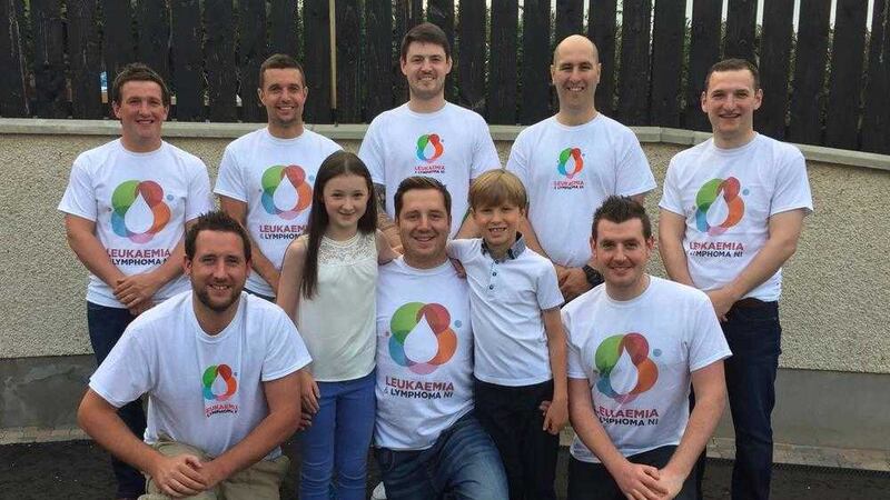 Barry Williamson pictured with his children Mya and Rhys and the team of family and friends who aim to climb the four highest mountains in the UK in just 48 hours in October 