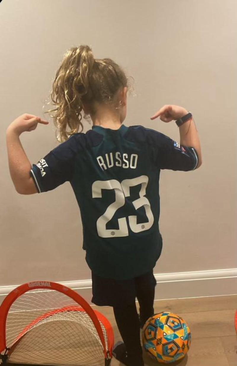 Girl wearing a Russo football shirt