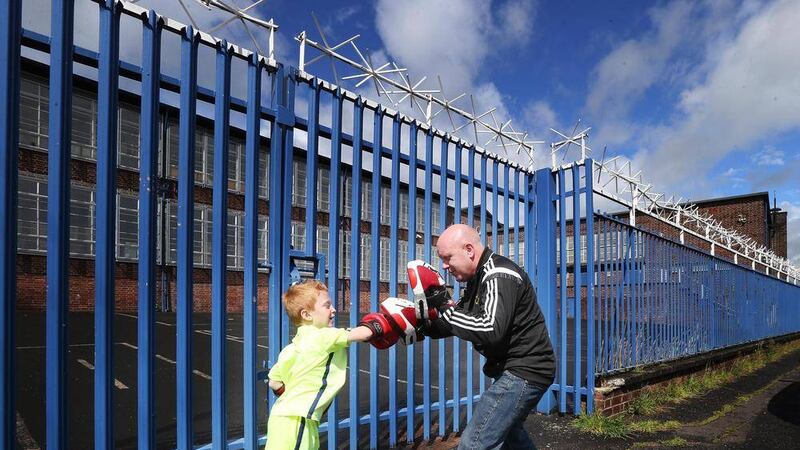 Paul Norton from Hillview ABC spars with young Jake McAlinden outside the vacant Ballygolan Primary School Picture Hugh Russell 