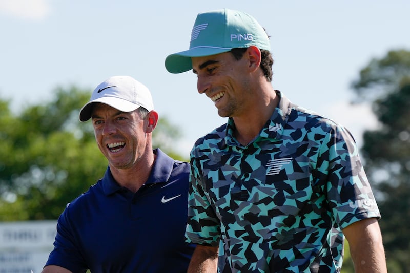 Rory McIlroy (left) and LIV Golf player Joaquin Niemann walk off the 18th hole after the final round of the 88th Masters (David J. Phillip/AP)
