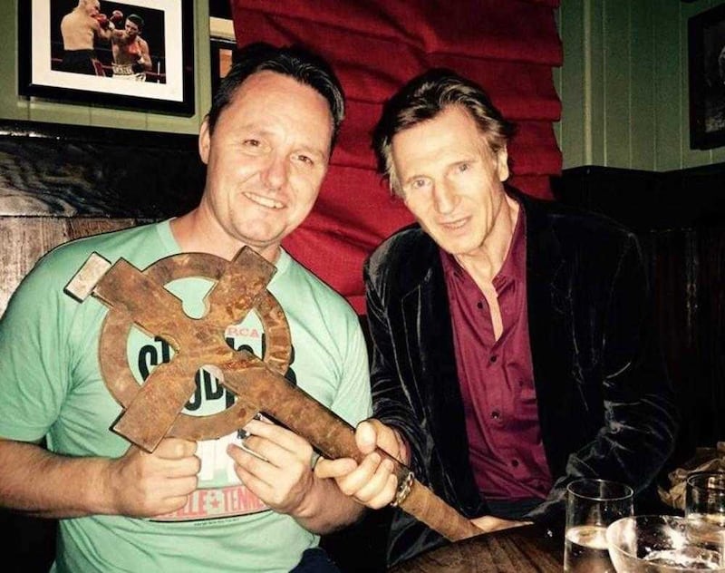 Sean Muldoon, co-owner of The Dead Rabbit in New York, with Liam Neeson and the Celtic Cross from Gangs of New York 