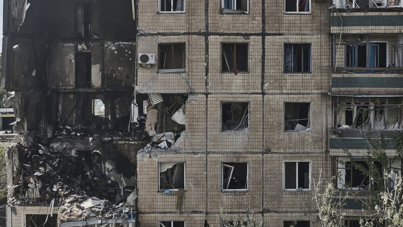 An apartment building was struck by a missile in Mr Zelensky’s home town (AP)