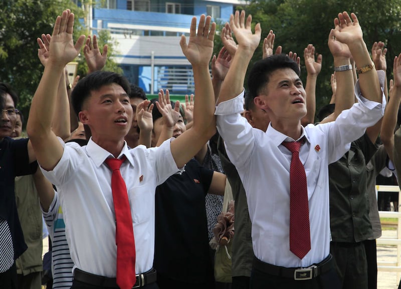 People reacting to the news of their country's latest nuclear test, at the Mirae Scientists Street in Pyongyang.