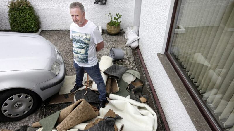 Ronnie McKee inspects the damage cause to his parents&#39; house which was damaged due the the heavy flooding at Muckamore Garden Village in Antrim at the weekend.   Picture by Ann McManus. 