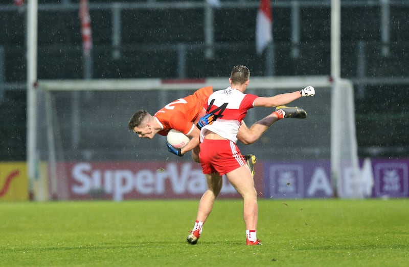 Derry's full-forward Shane McGuigan tangles with an Armagh opponent in 2020.