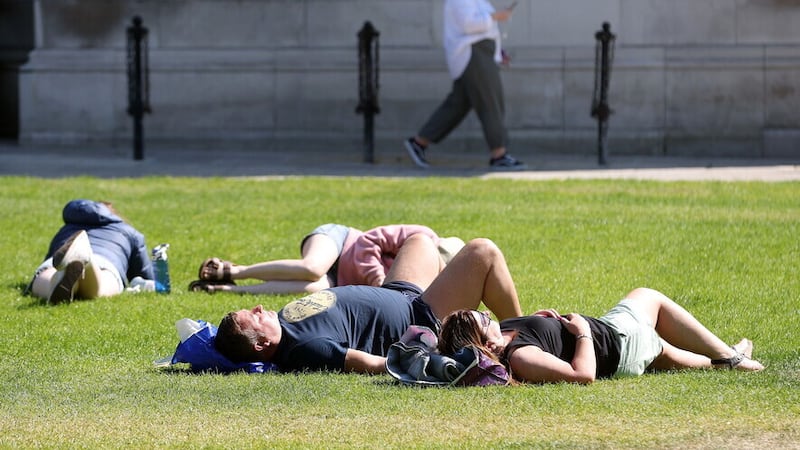 Sunbathers at Belfast City Hall at the beginning of June. Picture by Mal McCann