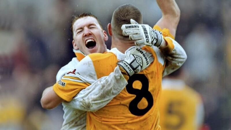 Sean McGreevy celebrates Antrim&#39;s victory over Down in 2000 with team mate Joe Quinn in Casement Park yesterday. Picture by Ann McManus 