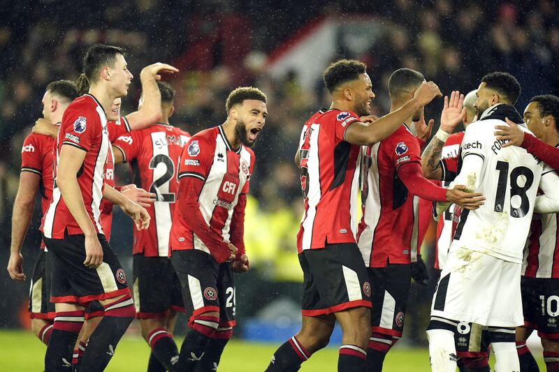 Sheffield United players embrace goalkeeper Wes Foderingham, second right, after his only clean sheet of the Premier League season