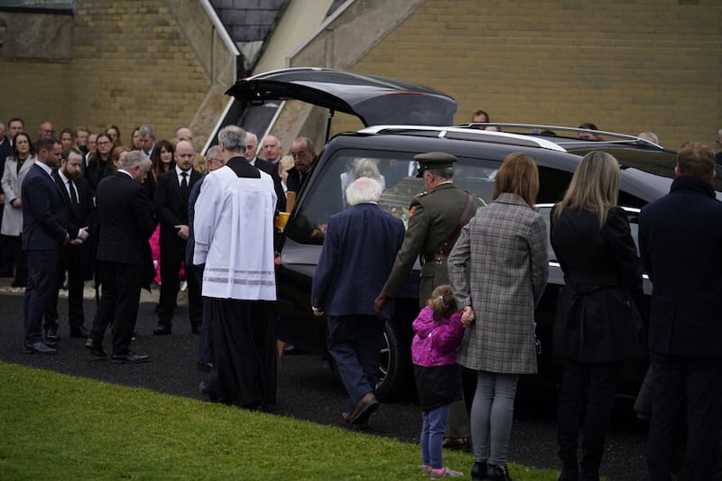 President Michael D Higgins (centre) arrives for the funeral Mass of James O'Flaherty at St Mary's Church, Derrybeg. Picture by Niall Carson, PA