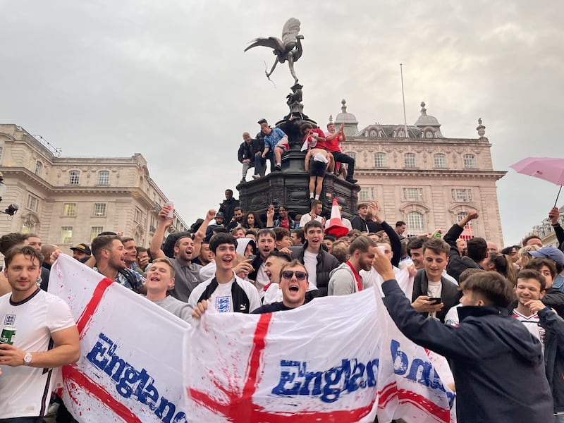 England football fans climb the statue of Eros in Piccadilly Circus, central London, celebrating England’s victory over Germany in the Euro 2020 round of 16 match. Picture date: Tuesday June 29, 2021