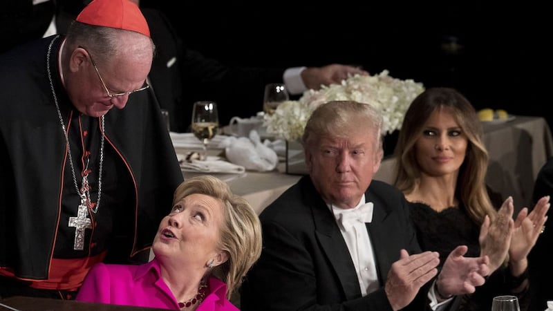 Republican presidential candidate Donald Trump and his wife Melania Trump watch as Democratic presidential candidate Hillary Clinton is helped into her chair by Cardinal Timothy Dolan, Archbishop of New York. Picture by&nbsp;Andrew Harnik, AP Photo