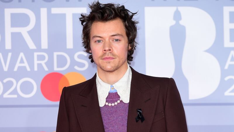 The singer, who is nominated for two Brit Awards, wore a black ribbon on the red carpet.