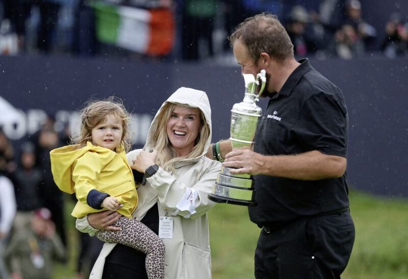 Shane Lowry celebrates with wife Wendy Honner and their daughter after winning the Claret Jug <br />Picture by PA