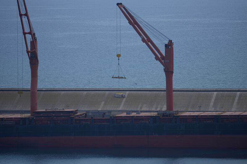 A crane loads food aid onto a ship in Cyprus (Petros Karadjias/AP)