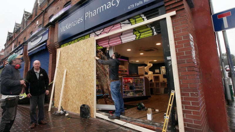 Workmen repairing the damage to McKenzies Pharmacy on the Falls Road, west Belfast. Picture by Ann McManus 