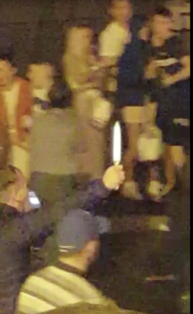 A still from a video which circulated on social media shows a man holding a knife 