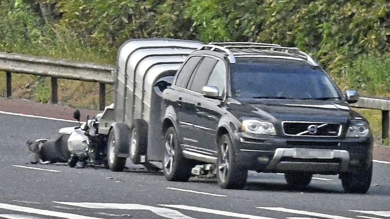Police closed the M2 after a serious crash between a motorbike and a car that was towing a trailer 