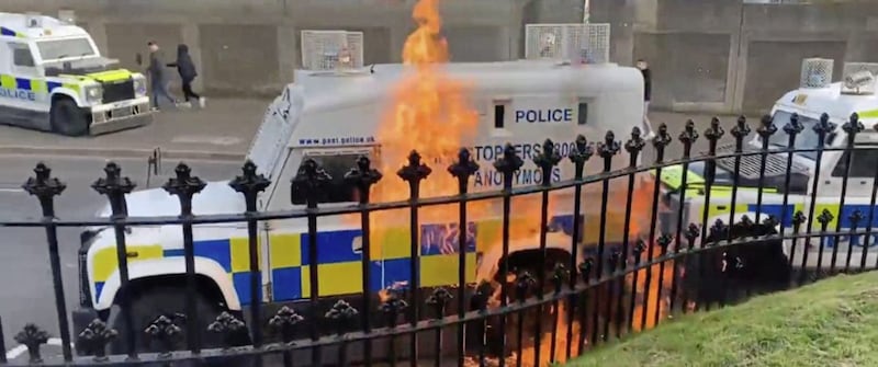A police Land Rover is hit by a petrol bomb thrown from inside Derry City Cemetery following an Easter parade in the city last year