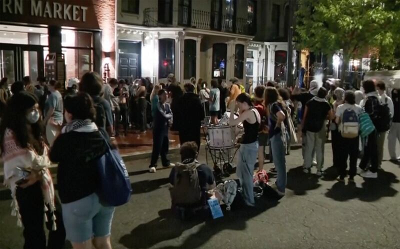In this grab taken from video, protesters protesting the Israel-Hamas war stand outside near the campus of George Washington University, in Washington (AP)