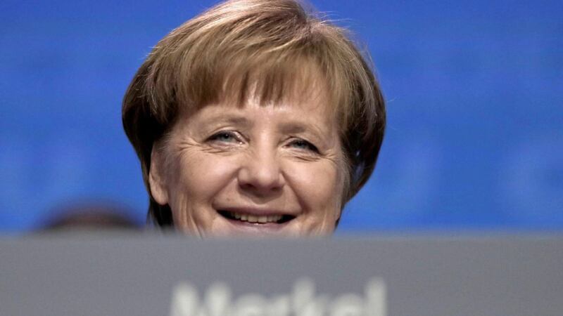 German Chancellor and party chairwoman Angela Merkel smiles at the party convention of the Christian Democratic Union CDU in Berlin. The members of the Social Democratic party voted for a coalition agreement with Merkel&#39;s party paving the way for Merkel&#39;s fourth term as German Chancellor. Picture by Markus Schreiber, file, Associated Press 
