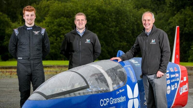Larne entrepreneur Sam Marsden with CCP Gransden&#39;s Robert McConnell and Jim Erskine alongside the Velocity motorcycle which he will drive in his world land speed record attempt next year. Photo: Brian Thompson Photography 