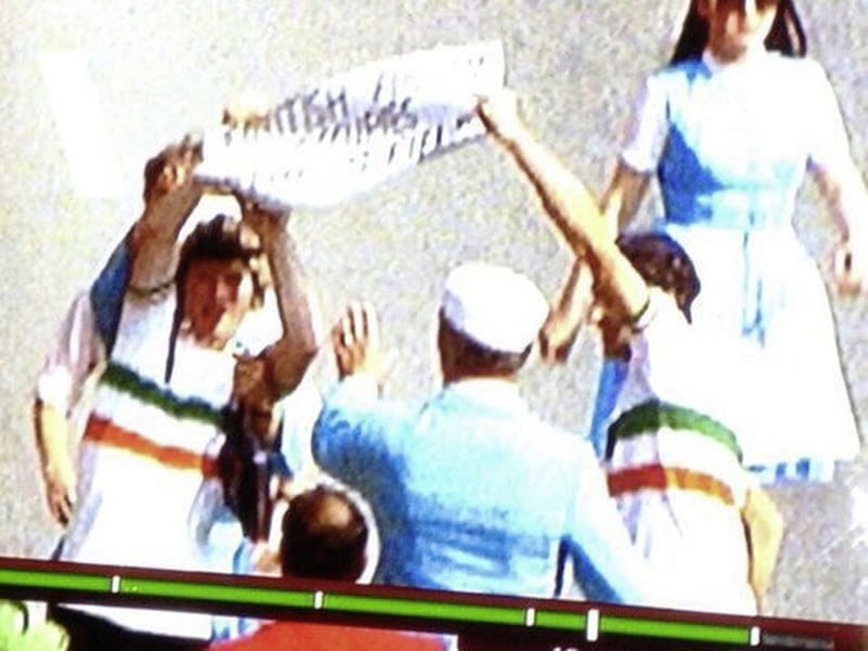 Brian Holmes (left) and Gabriel Howard captured on television cameras holding up a banner that read &lsquo;British army occupies our sporting fields&rsquo; after making their way to the start line of the Munich Olympics road race