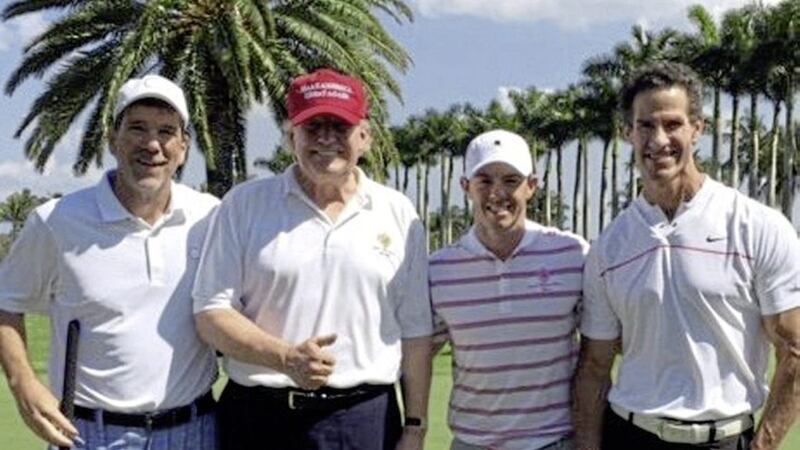 Rory McIlroy, third left, with US president Donald Trump, second left, in Florida where they played a round of golf earlier this year. The Holywood golfer has said he would think twice before playing with Trump again after the backlash he received 