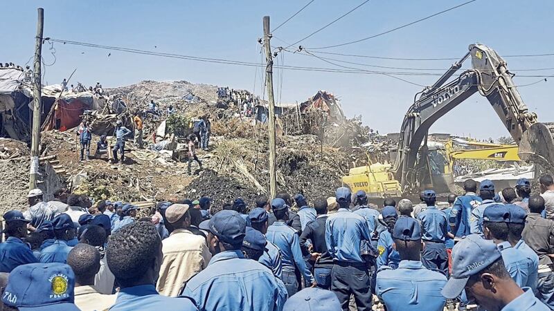 Police officers secure the perimeter at the scene of a garbage landslide, as excavators aid rescue efforts, on the outskirts of the capital Addis Ababa, yesterday. Picture by Elias Meseret, Associated Press 
