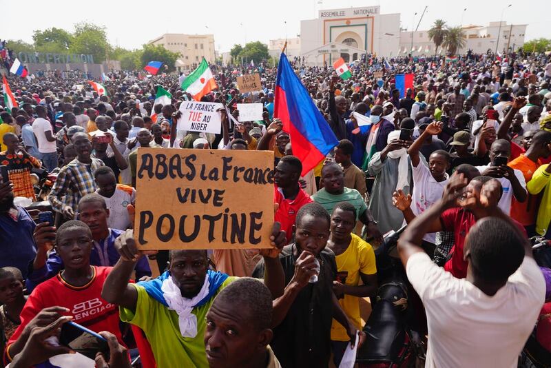 Nigeriens participate in a march called by supporters of coup leader General Abdourahmane Tchiani in Niamey, Niger