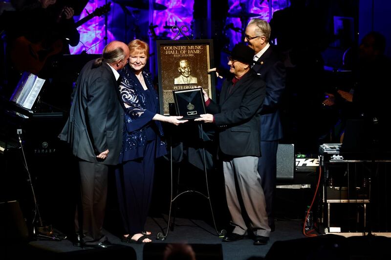 Rose Drake and John Drake are presented the medallion for Pete Drake by Charlie McCall and Kyle Young, CEO of the Country Music Hall of Fame and Museum, during the Country Music Hall of Fame Medallion Ceremony in Nashville, Tennessee 