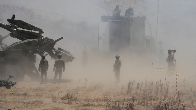 Dust billows as Philippine Army fires Atmos 155mm howitzers during a joint military exercise in Laoag, Ilocos Norte (Aaron Favila/AP)
