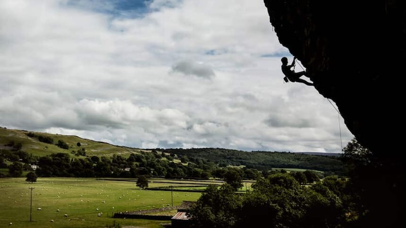 A rock climber on Kilnsey Crag, one of Yorkshire’s ‘Big Three’ limestone rock face, in the Yorkshire Dales National Park (Danny Lawson/PA)