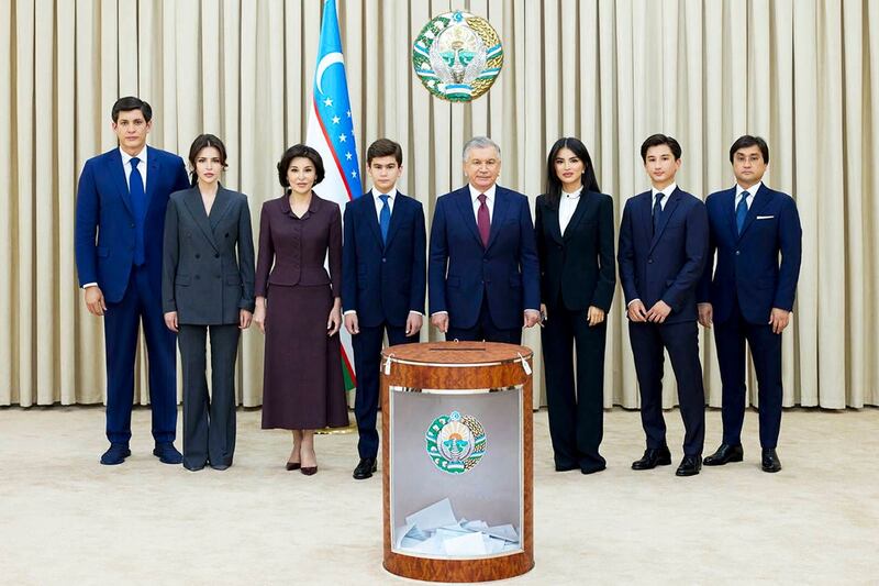 Uzbekistan’s president Shavkat Mirziyoyev, fourth right, poses with family members after voting 