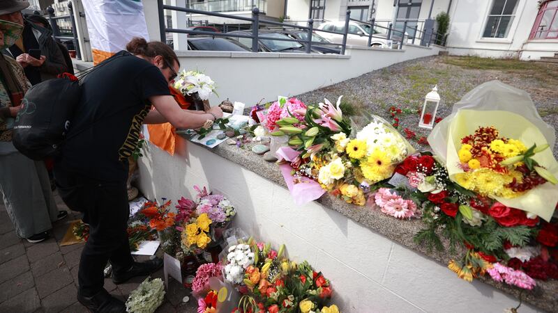 A man writes a tribute outside the former home of Sinead O’Connor (Liam McBurney/PA)