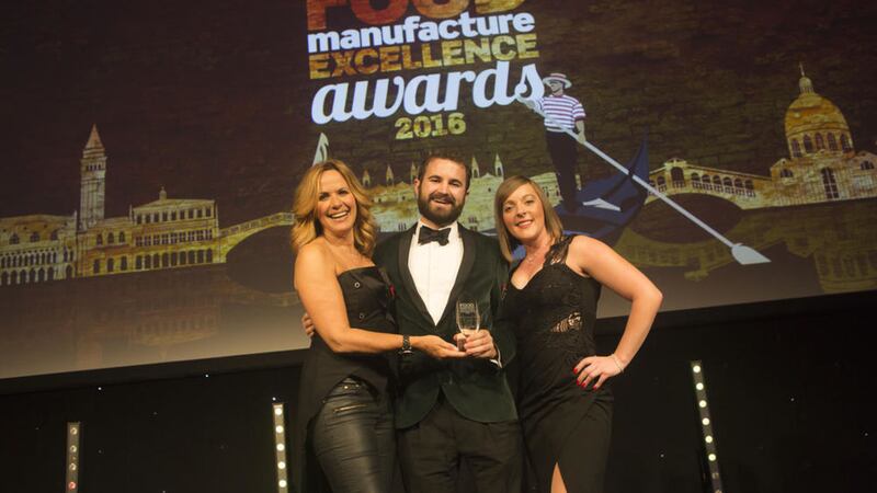 Jack Hamilton, Mash Direct receives the food manufacturing company of the year trophy from Carol Smillie and a representative of award sponsor Michael Page Recruitment