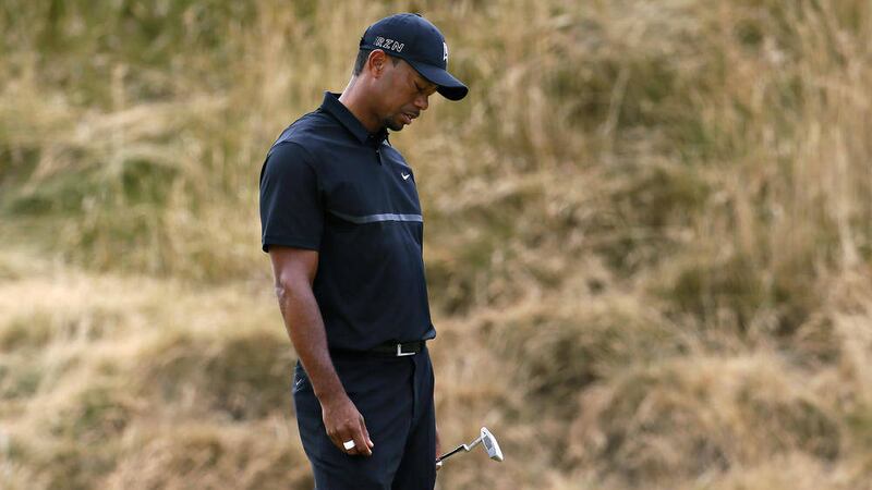 Tiger Woods reacts to a poor putt on the sixth hole during the first round of the U.S. Open golf tournament at Chambers Bay 