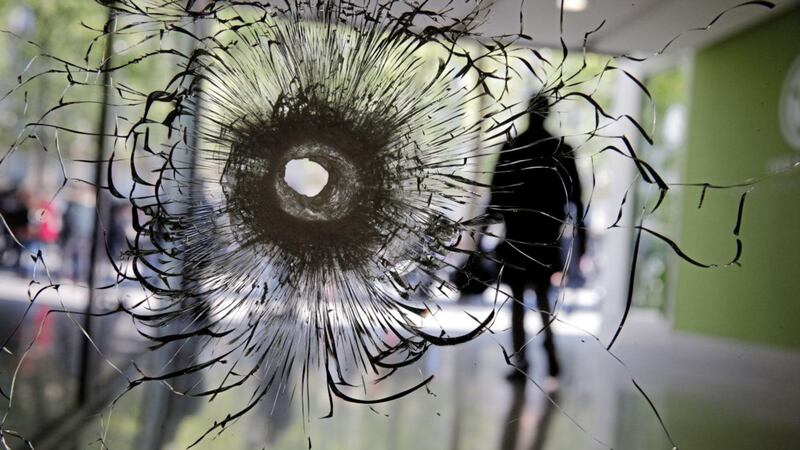 A bullet hole in a shop window on the Champs Elysees boulevard in Paris Picture by Christophe Ena/AP 